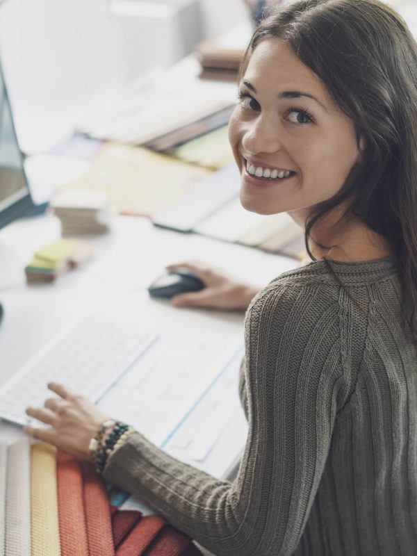 smiling-interior-designer-working-at-desk-1.jpg